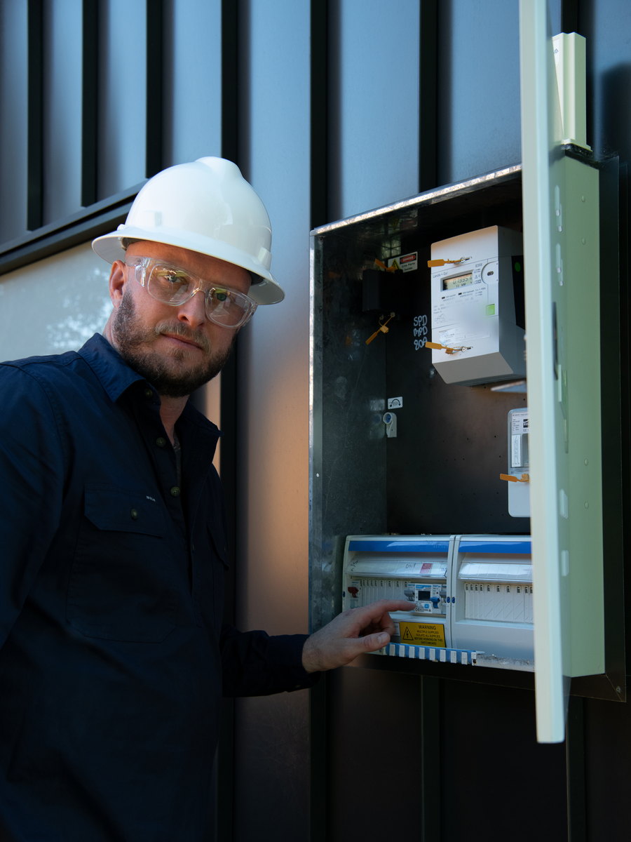 Toby McCosker inspecting a switchboard as a licensed electrical contractor